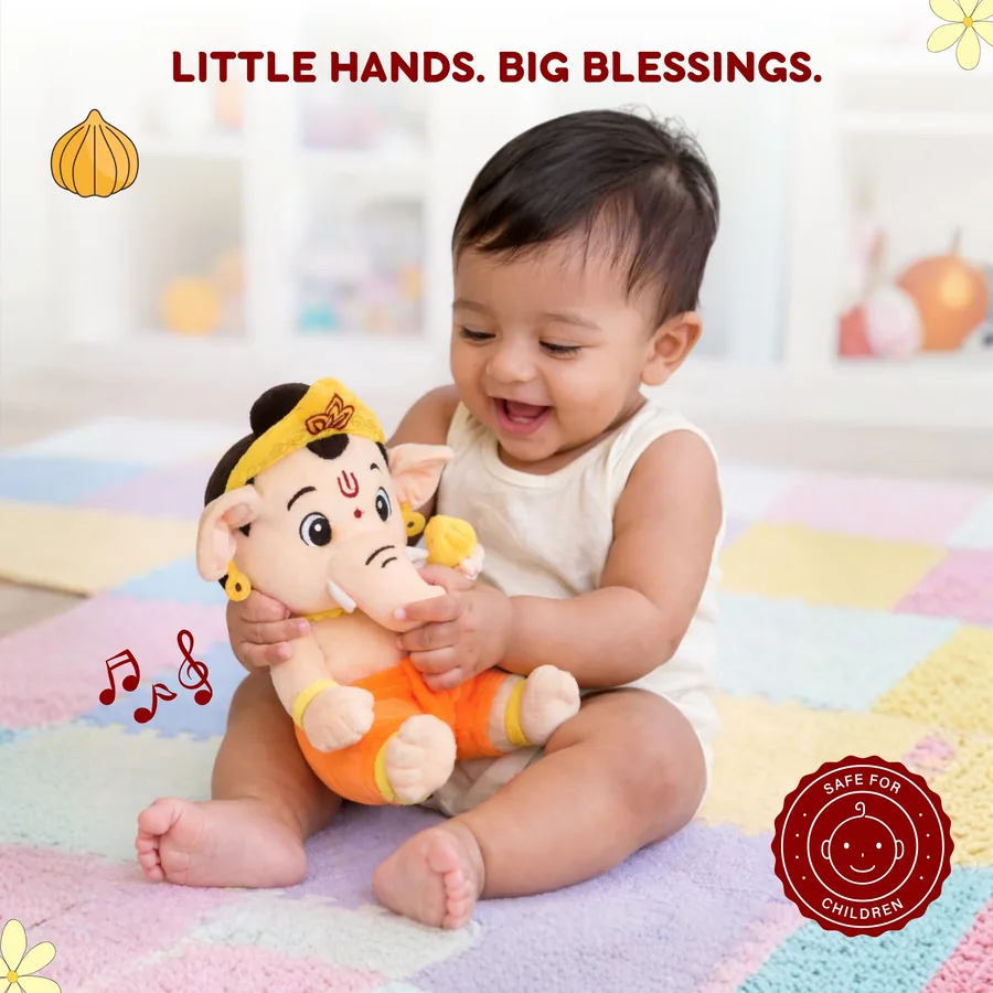 Baby happily holding the Mantra Ganesha plush